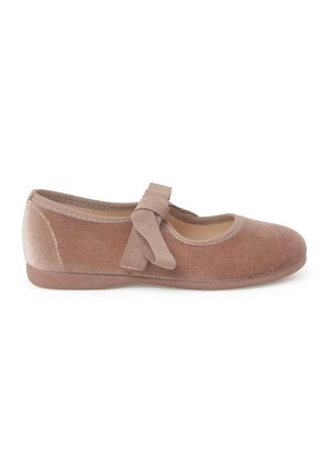 Velvet ballet flat in dusty pink with a round toe, elasticized strap with a bow, and flat rubber sole. Smooth texture throughout.