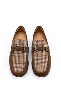 Mocasines de ante marrón con un tejido de pata de gallo en la parte superior, acentuados con un detalle de hebilla de metal y bordes cosidos.