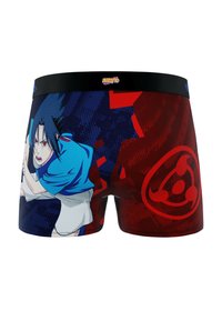 Un short de boxeur avec une ceinture noire présente un design graphique d'un personnage bleu et rouge, sur fond à pois.