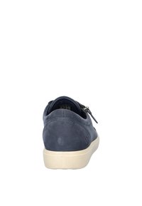 Navy blue suede sneaker with a rounded shape, contrasting beige sole, smooth texture, and zipper accent on the side.