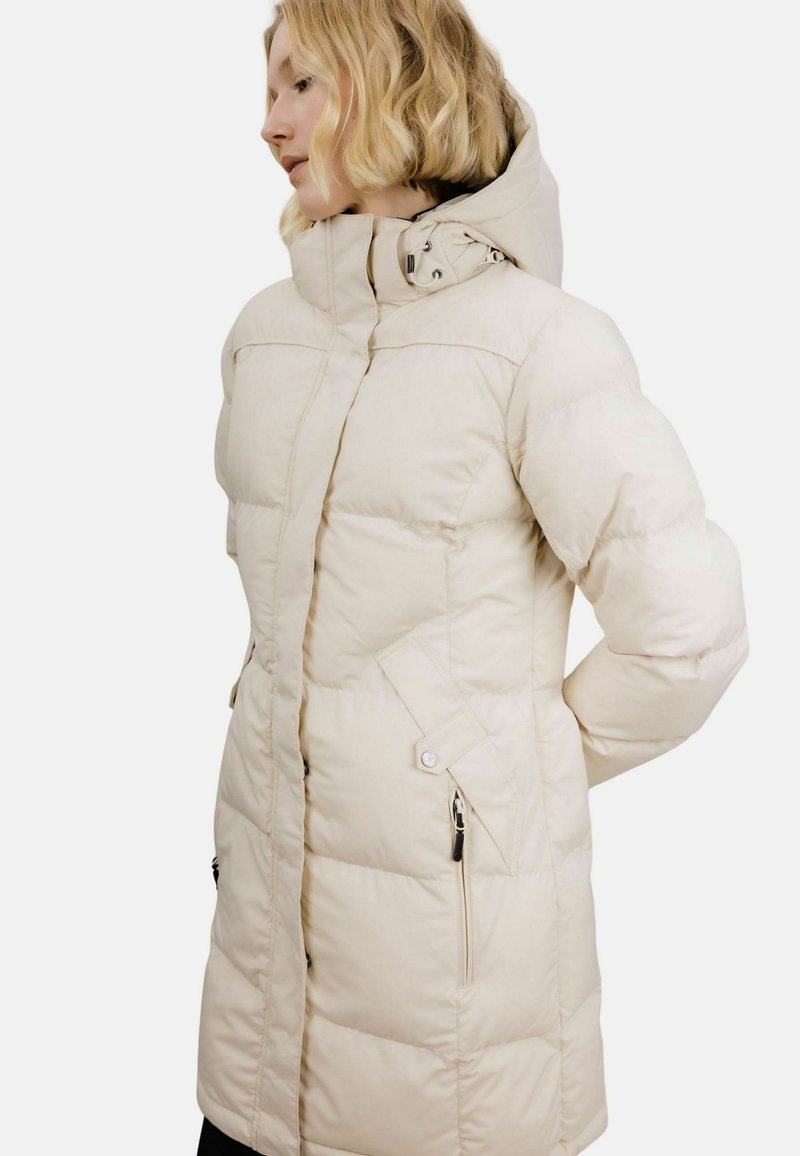 Pufferjakke i lys beige med høy krage og glidelås foran. Teksturert, quiltet design med sidelommer og justerbar hette.