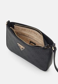 Czarna torebka ze sztucznej skóry z elementami w kolorze złotym, trójkątnym logo, zamkiem błyskawicznym oraz beżowym wnętrzem wyściełanym podszewką z logo.