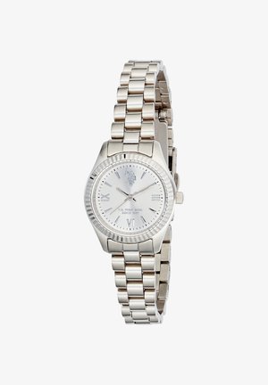 Montre-bracelet en acier inoxydable argenté avec bracelet à maillons, cadran rond, chiffres romains aux positions 3, 6, 9 et 12, et logo de la marque sur le cadran.