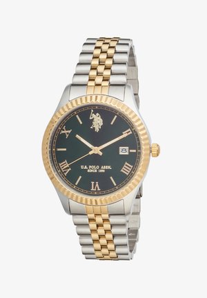 Montre-bracelet en métal bicolore argent et or avec cadran noir, chiffres romains, fenêtre de date et logo ainsi que texte de U.S. Polo Assn. sur le cadran.