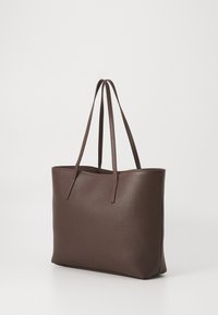 Brown leather tote bag with a textured surface and two long straps, featuring a rectangular shape and open-top design.