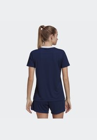 Navy athletic jersey with short sleeves and a round white collar, paired with navy shorts. Fabric appears lightweight and smooth.