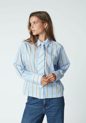 Light blue long-sleeve shirt with vertical yellow stripes and a matching tie, featuring a classic collar and buttoned cuffs.