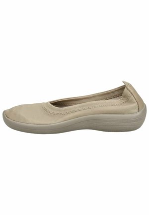 Beige women's slip-on shoe with soft leather upper and cushioned sole designed for comfort and casual wear.