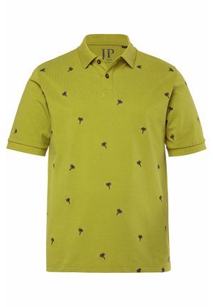 Green polo shirt made of cotton, featuring a collar and short sleeves. It has an all-over black palm tree pattern and two buttons at the neck.