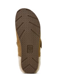 Brown suede boot sole featuring a textured rubber bottom with a patterned grip; branding detail embedded in the material.