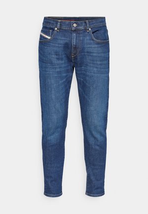 Denim jeans in dark blue, featuring a straight cut, five pockets, and gold stitching details. Standard waistband with a button closure.