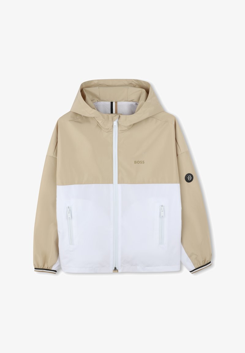 Giacca con cappuccio beige e bianca, caratterizzata da una chiusura a zip completa, due tasche con zip e un dettaglio con logo sul petto. Tessuto morbido e liscio.