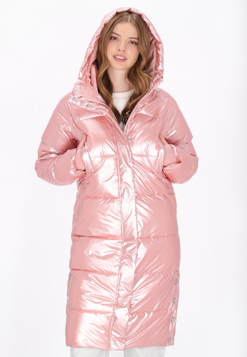 Rózsaszín puffertava fényes, fémből készült felülettel, hosszú fazonú, levehető kapucnival, oldalsó zsebekkel és gombdíszítéssel az alján.