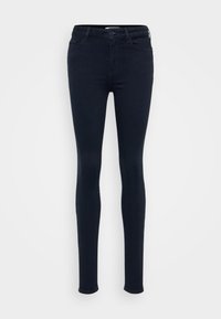 Mörkblå, smala jeans tillverkade av stretchdenim; har knappstängning, bältesloopar och två framfickor. Slät yta genomgående.