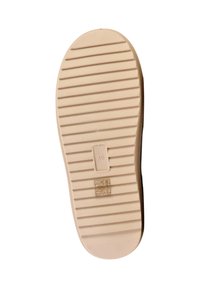 Semelle de chaussure avec rainures horizontales, taille 40 marquée au centre, couleur beige, et petits symboles de matériau et d'entretien près du talon.