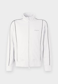 Biała kurtka sportowa na zamek z czarnymi lamówkami na rękawach i przodzie, elastycznym pasem oraz małym logo Armani Exchange na lewej piersi.
