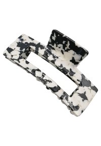 Clip per capelli in plastica liscia con motivo a marmo bianco e nero, dotato di un'apertura rettangolare e di una sezione con superficie zigrinata per una migliore presa.