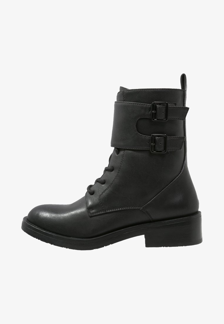 Black leather ankle boot with lacing, two buckle straps, rounded toe, and a chunky heel. Smooth texture and sturdy design.