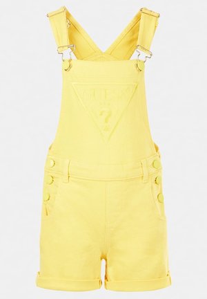 Salopette en denim jaune avec un logo triangulaire embossé, une boucle de réglage sur la bretelle et un détail à plusieurs boutons sur le côté. Shorts à ourlet retroussé.
