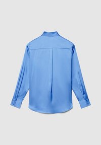 Long-sleeve light blue satin shirt with buttoned cuffs, back yoke seam, and center pleat, displayed on a plain light gray background.