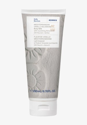 Tube de lait corporel Fleur de Vanille Méditerranéenne avec huile d'amande, nourrit et adoucit pendant 24 heures, 200 ml, design floral beige texturé.
