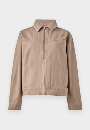 Beige Baumwolljacke mit Kragen, Frontreißverschluss und langen Ärmeln. Verfügt über einen strukturierten Stoff und ein kleines Logotag am Saum.
