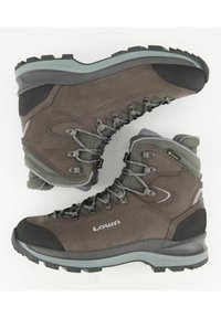 Braune Wanderschuhe mit grauen Akzenten und einem strukturierten Wildlederfinish. Vibram-Sohle mit tiefen Profilen für besseren Halt. Mit GORE-TEX-Label.