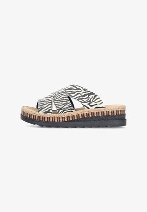 Slip-on Sandale mit schwarz-weiß zebra-gestreiften, überkreuzten Riemen, strukturierter hellbrauner Zwischensohle und schwarzer Gummisohle.