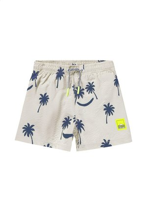 Shorts de bain beiges avec imprimé de palmiers bleu marine, taille élastique avec cordon de serrage, et un écusson logo jaune néon à l'avant.