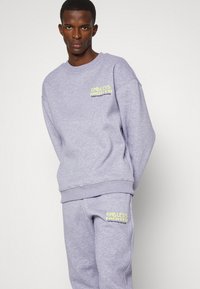 Endless Nights UNIFORM ESSENTIALS UNISEX - Calças de fato de treino - sport grey