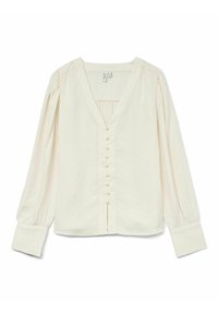 Blouse crème clair avec un col en V, des manches longues bouffantes et une fermeture à boutons à l'avant avec de petits boutons ressemblant à des perles. Tissu texturé.