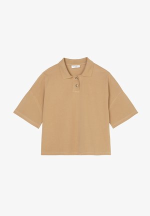 Short-sleeve polo shirt in light brown cotton. Features a classic collar, three-button placket, and relaxed fit. Smooth texture, minimal design.