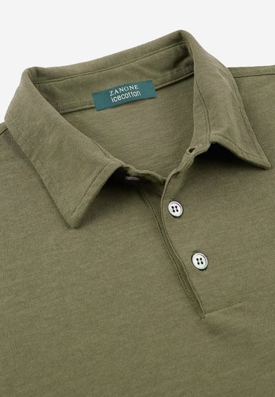 Polo shirt verde oliva con colletto classico, due bottoni e dettaglio tasca. Realizzato in morbido tessuto di cotone ghiaccio per il massimo comfort.
