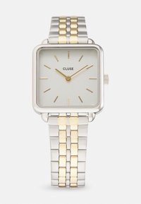 Montre à cadran carré avec un bracelet en acier inoxydable argent et doré, un face grise minimaliste, des index horaires dorés et le logo Cluse à 12 heures.