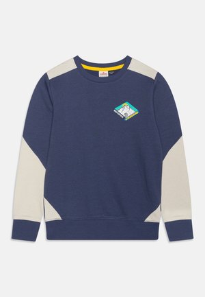 Granatowa bluza z kremowymi akcentami na ramionach i rękawach. Na piersi znajduje się logo w kształcie diamentu z grafiką gór. Mieszanka bawełny.