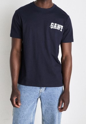 Navyblauwe T-shirt met korte mouwen van katoen, met een ronde hals en witte gedrukt tekstontwerp op de voorkant. Casual pasvorm met een soepele textuur.