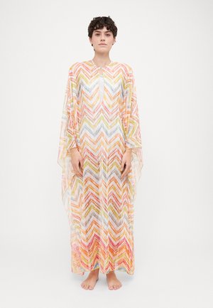 Multicolored kaftan featuring a zigzag pattern in pastel tones, with a round neckline and flowing fabric that drapes to the ankles.