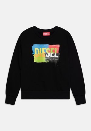 Felpa nera con un design a macchie di vernice multicolore e la scritta "DIESEL PER UNA VITA DI SUCCESSO" in caratteri in grassetto.