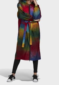 Barevný dlouhý deštník s kapucí, s gradientním designem v červené, zelené a modré. Obsahuje pásek a zapínání na zip.