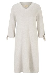 Robe tricotée beige clair avec un décolleté en V, des manches trois-quarts nouées par de petits nœuds aux poignets, et un ourlet légèrement évasé.