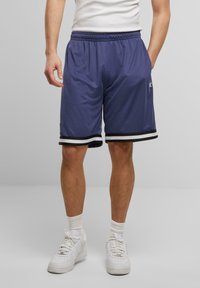 Shorts de sport bleus avec un ourlet rayé noir et blanc, fabriqués en tissu léger, dotés d'une taille élastique et de poches latérales.