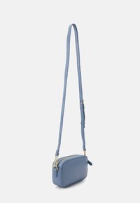 Light blue crossbody bag made of textured leather, featuring a zip closure, slim adjustable strap, and gold-tone hardware accents.