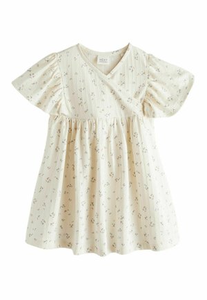 Robe pour bébé de couleur crème avec un petit motif floral, des manches courtes bouffantes, un col en V et une taille froncée.