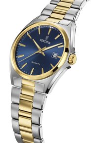 Festina kvarčni športni uro z modrim ciferblatom, zlatimi detajli, srebrnim in zlatim nerjavečim jeklenim zapestjem, prikazom datuma in minimalističnimi kazalci.