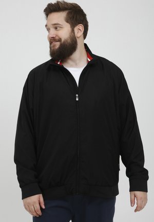 Black zip-up jacket made of lightweight material, featuring a stand collar with red and white stripes, elastic cuffs, and a relaxed fit.