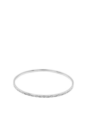 Thin silver bangle bracelet with small round clear stones set in a repeating oval pattern around the band.