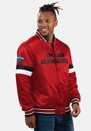 Red satin Chicago Blackhawks jacket with black and white striped accents, front snap closure, and embroidered logo on the chest and sleeve.