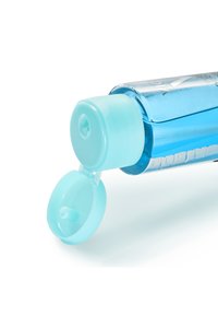 Clear plastic bottle with blue liquid, featuring a light blue flip-top cap and a small nozzle for dispensing. Transparent design showcases contents.