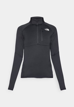 Pulôver preto de mangas compridas com colarinho de meia-zíper, apresentando um bolso no peito e um logotipo branco do lado esquerdo. Tecido suave e elástico.