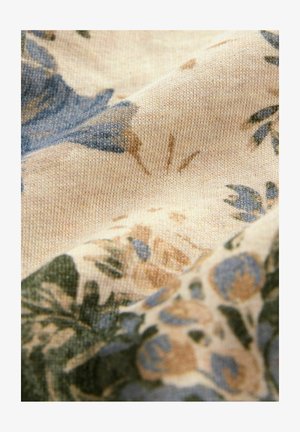 Květinová látka s béžovými, modrými a zelenými vzory; textura je měkká a pletená, s propracovanými designy květin a listů.